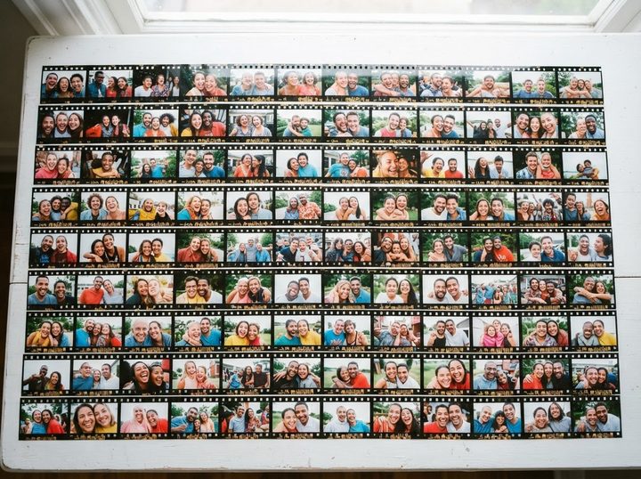 A contact sheet of candid portraits spread on a table